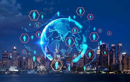 Manhattan downtown, New York skyscrapers at night. Earth sphere hologram, worldwide social network circuit. Icons with people. Concept of finance and communicationの写真素材