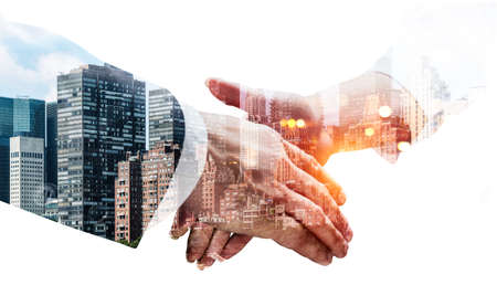Businessman and businesswoman shaking hands, double exposure with New York City and skyscrapers. Concept of partnership and success. Mockup copy spaceの写真素材