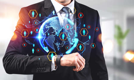 Businessman looking at smart watch on hand, hud hologram with earth globe, worldwide social network....
