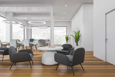 White office interior with lounge zone and coffee table. Workplace with chairs and table on hardwood...