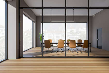 Dark conference room interior with armchairs and table, hardwood floor. Office minimalist meeting room and panoramic window on countryside. 3D renderingの写真素材