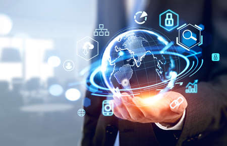 Businessman hand hold earth globe hologram, office room on background, digital icons and connection....