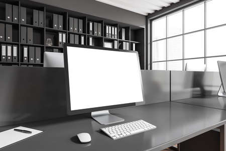 Dark workplace interior with pc computer, side view, desk and shelf with documents. Panoramic window...