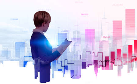 Businesswoman writing in business clipboard, back view. New York skyline forex bar chart with...