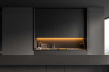 Dark countertop on background of black kitchen interior with kitchenware and backlight, panoramic window. Mockup copy space for product display. 3D renderingの写真素材