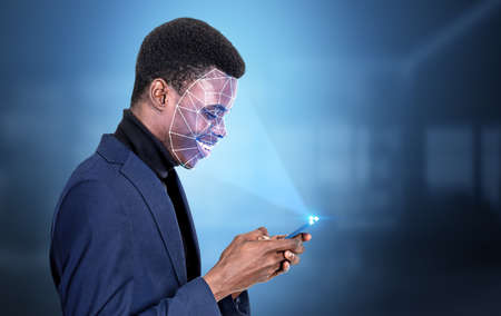 Black businessman profile typing on smartphone in hands, digital biometric scanning. Face detection...