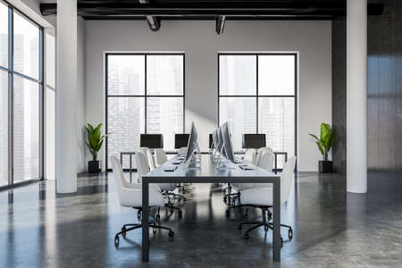 Dark business interior with armchairs and pc computer in row, gray concrete floor. Coworking loft with panoramic window on Singapore city view. 3D renderingの写真素材