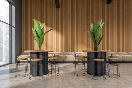 Cafe interior with bar chairs and table with plant. Restaurant dining space on beige concrete floor....