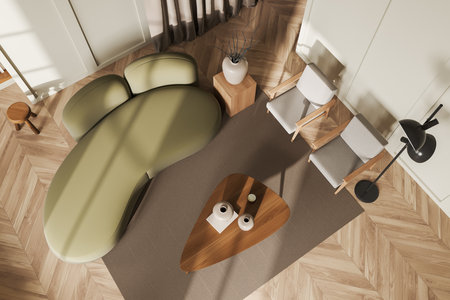 Top view of light living room interior with sofa and two armchairs, coffee table with decoration,...