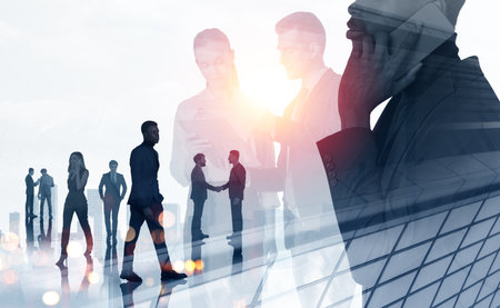Silhouettes of white and black business people working together, calling and handshake. Double...