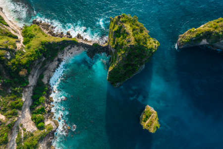 Aerial drone top view shot of rocky beach with cliff. Indian ocean shore. Copy space for text....