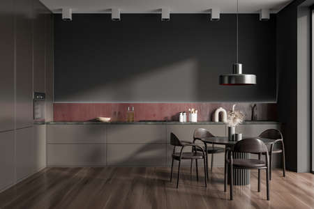 Brown kitchen interior with chairs and dining table on hardwood floor, front view. Kitchenware on...