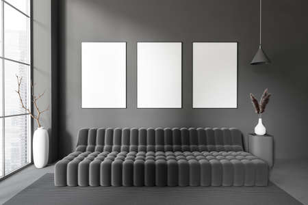Dark lounge interior with sofa, stand and vase with dried flower, carpet on dark concrete floor....