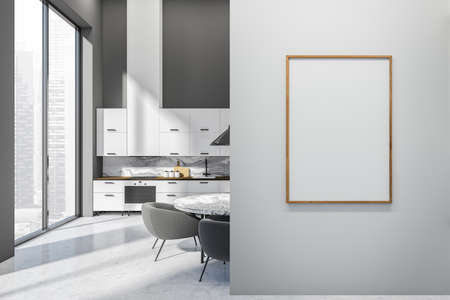 Light kitchen interior with chairs and dining table on light concrete floor. Cooking appliances and...