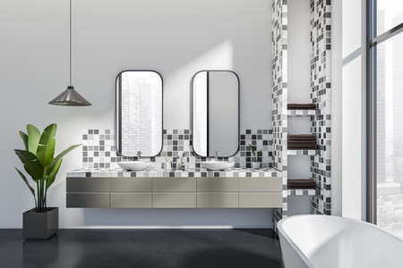 Front view on bright bathroom interior with bathtub, two mirrors, panoramic window with city...