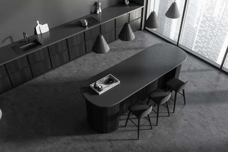Top view on dark kitchen room interior with island, barstools, cupboard, gray wall, concrete floor,...