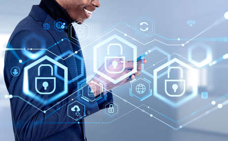 Black businessman smiling profile using phone in hands, cybersecurity lock chain and digital icons...