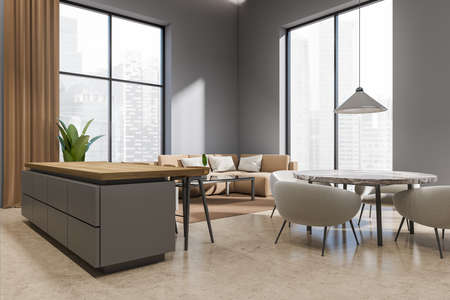Brown studio interior with bar island, side view, dining table with chairs and sofa in the corner, beige concrete floor. Panoramic window on Singapore city view. 3D renderingの写真素材