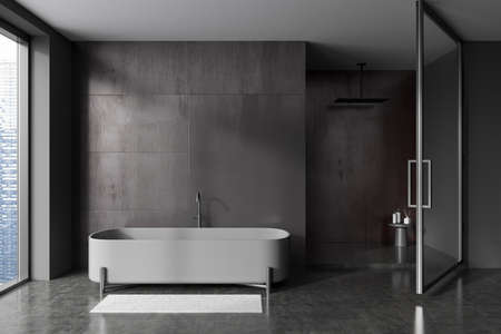 Front view on dark bathroom interior with bathtub, shower, panoramic window with city view, stool,...