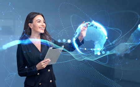 Smiling businesswoman with tablet, finger touch earth globe, glowing sphere and digital network...