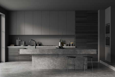 Front view on dark kitchen room interior with island, barstools, cupboard, gray wall, oven, concrete floor, crockery, gas cooker, shelves. Concept of minimalist design. 3d renderingの写真素材