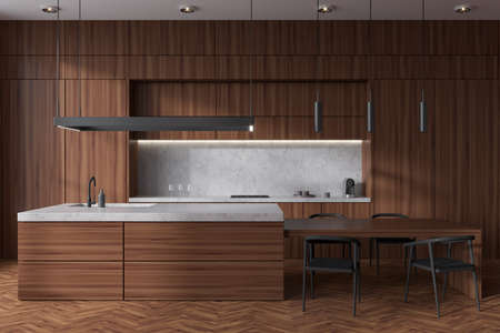 Wooden kitchen interior with chairs and bar island on hardwood floor. Cooking area with kitchenware...