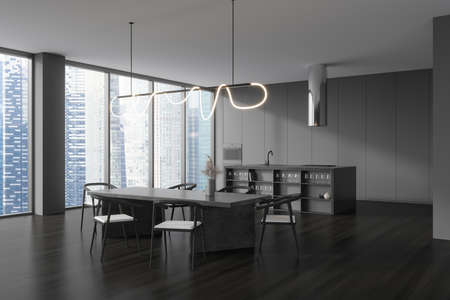Dark kitchen interior with chairs and dining table on black hardwood floor, side view, bar...