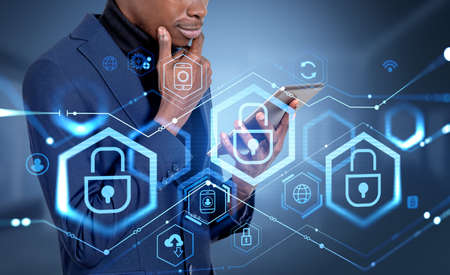 Black businessman with tablet in hands, pensive and smiling look, double exposure with glowing...