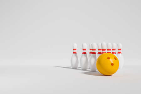 Yellow bowling ball and ten pins on white background. Concept of sports and activities. copyspace. 3D renderingの写真素材