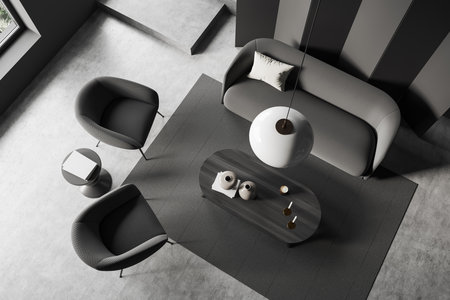 Top view of dark living room interior with sofa and two armchairs, coffee table with candles and...