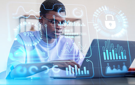Black businessman working with laptop, virtual screen with digital statistics and numbers hud,...