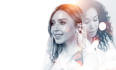 Multinational businesswoman working together, two portrait silhouettes on white empty background....
