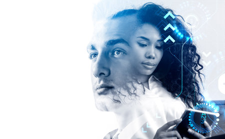 Serious businessman wearing formal wear and attractive businesswoman working together thinking about profitable creative ideas for business. digital interface. Concept of teamwork, partnership, coworkingの写真素材