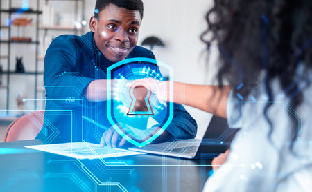 African American businessman shakes hands with businesswoman signing contract. Laptop at office...