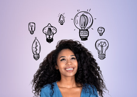 Dreaming african woman portrait looking up, different light bulb doodle on lilac background. Concept of brainstorm and new ideaの写真素材