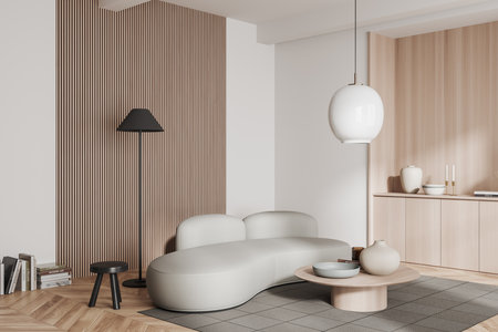 Corner view on bright living room interior with sofa, coffee table with books and crockery, white...