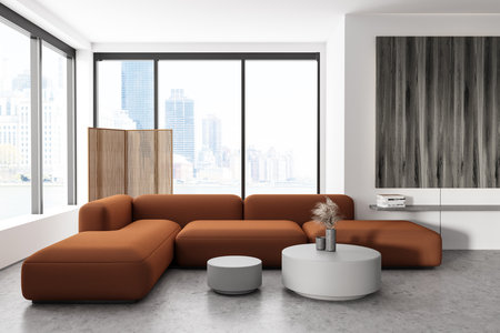 White living room interior with sofa and coffee table with decor, gray concrete floor. Shelf with...