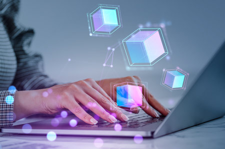 Businesswoman fingers typing on laptop, double exposure with digital hologram of blocks floating. Concept of blockchain and metaverseの写真素材