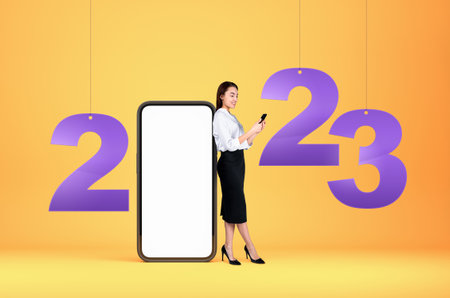Businesswoman standing near large mockup blank smartphone display, full length working with a phone....