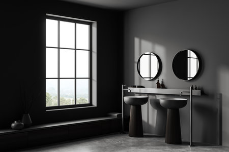 Corner view on dark bathroom interior with double sink, two round mirrors, window, gray walls, liquid soap, concrete tile floor. Concept of water treatment. 3d renderingの写真素材