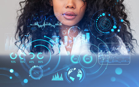 Black businesswoman looking at laptop, double exposure with forex diagrams and global financial statistics. Concept of online trading and researchの写真素材