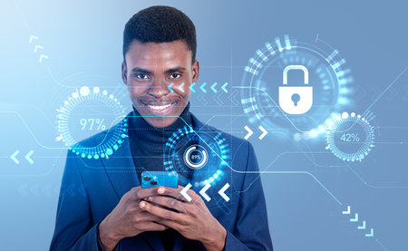 Smiling black businessman typing on smartphone. Cybersecurity hologram hud, percentage circles and connection, glowing padlock. Concept of data protectionの写真素材