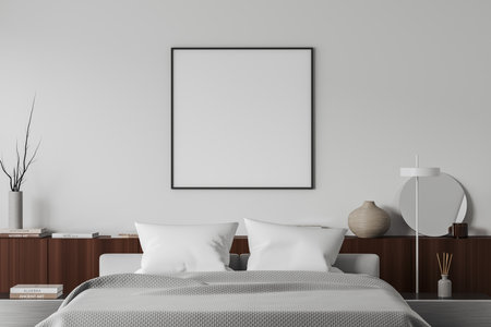 Front view on bright bedroom interior with empty white poster, bed, bedsides, shelf with books, round mirror, white wall. Concept of minimalist design, chill and relaxation. Mock up. 3d renderingの写真素材
