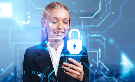 Smiling businesswoman with phone in hand, big padlock and digital abstract lines. Concept of encryption and business data protection.の写真素材
