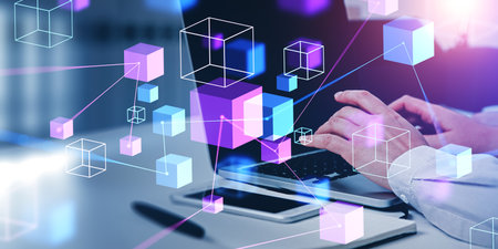 Businessman fingers typing on laptop, double exposure with digital hologram of blocks floating and...