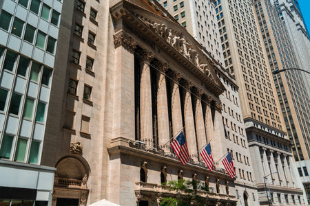 New York wall street, stock exchange building and three american flags in row. Concept of money...