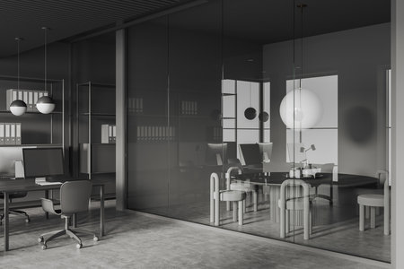 Dark business interior with coworking and conference room behind glass doors, side view. Workplace corner with desk and pc computer, gray concrete floor. 3D renderingの写真素材