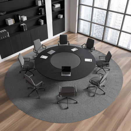 Top view of office interior with meeting table, armchairs and laptop, carpet on hardwood floor....