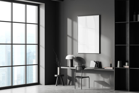Corner of stylish home office with gray walls, concrete floor, wooden table with laptop and vertical mock up poster above it and dark wooden bookcase. Window with blurry cityscape. 3d renderingの写真素材