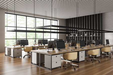 Stylish office interior with armchairs and pc computer on shared desk in row, side view hardwood floor. Coworking corner shelf and panoramic window. 3D renderingの写真素材